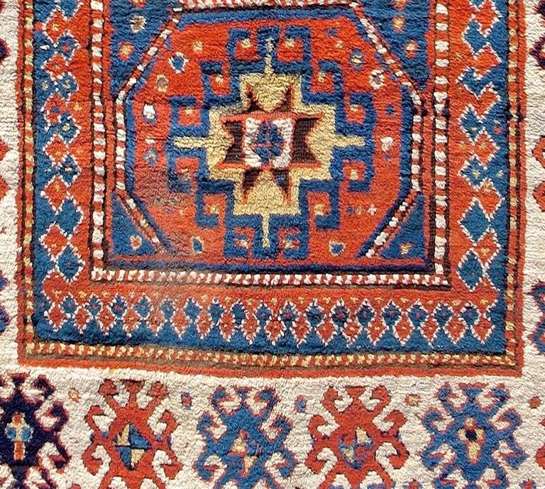 Wool Late 19th Century Geometric Red Caucasian Kazak Rug with Three Medallions For Sale