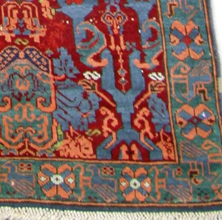 Kuba rugs designated as Seichor,  are known for their distinctive vibrant palette,  with prominent medium blues, scarlet reds and accents in pink and gold. Stylistically, these pieces often reflect the European and particularly French taste of the