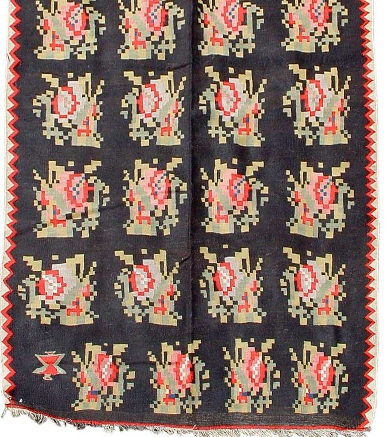 Utilizing both Ottoman and European aesthetics and modes, this Besserabian flat-weave was woven in the Northeast of the country by the Black Sea either very close to or in the area now that is Moldova. The dark ground recalls weavings from Karabagh