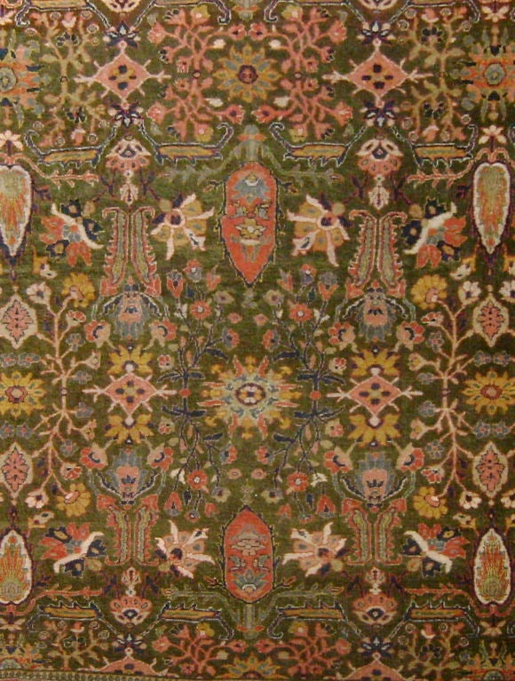 The green field of this carpet is quite rare. (Indeed, naturally dyed greens were often more complicated to achieve as they were always double-dyed.) In the later nineteenth century workshops were established in central Persian weaving centers such