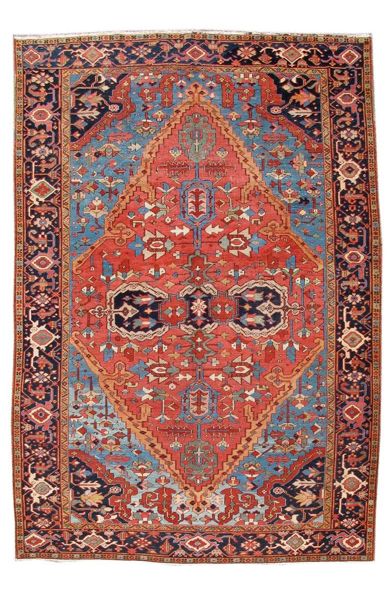 The color, drawing and composition of this piece remain remarkably faithful to the tradition of earlier Bakshaish weaving from the 19th century. An elongated medallion nearly the entire length of the field stretches across a light blue ground with