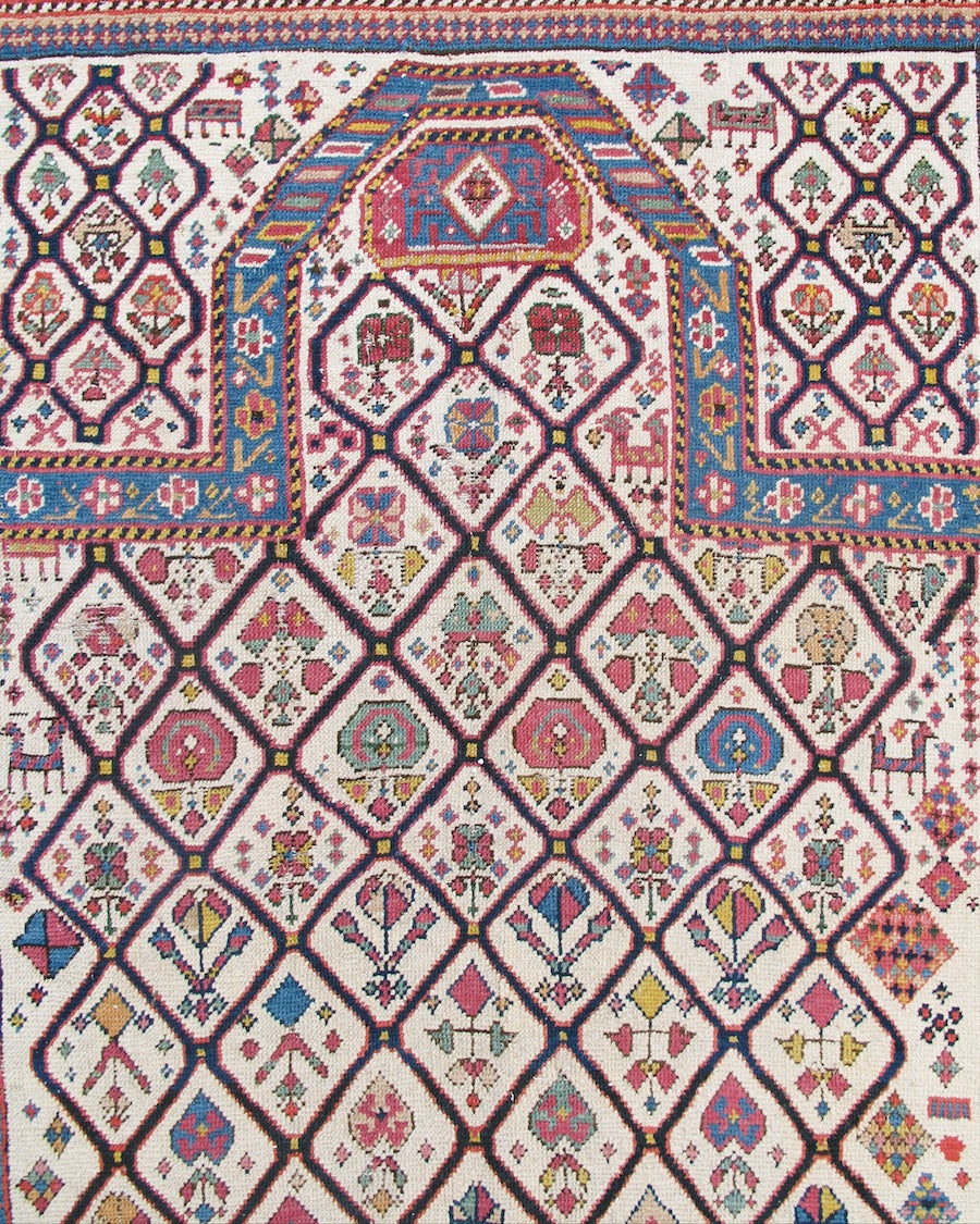 Within each genre of rugs and carpets there are examples that typify their group and others with added charisma that exemplify great weaving. This exceptional Shirvan prayer rug belongs to the latter category. Colorful flowering plants are drawn