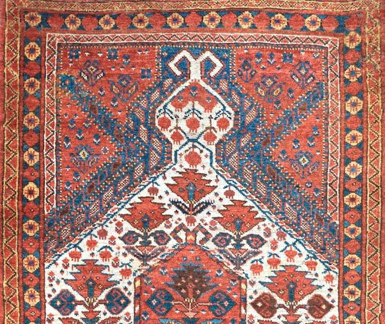 This exceptional Central Asian prayer rug was most probably woven by ethnic Turkmen weavers in the area of the Oxus River in what is now Uzbekistan. Clusters of pomegranates hang against a large central white mihrab niche while stylized flowering