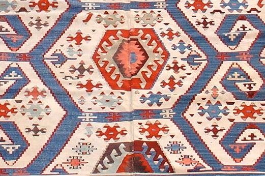 This striking flat-woven Turkish kilim was woven in central Anatolia around the area of the town of Konya in the late nineteenth century. In traditional Turkish village fashion it was woven in two halves on a narrow loom, the two halves then joined