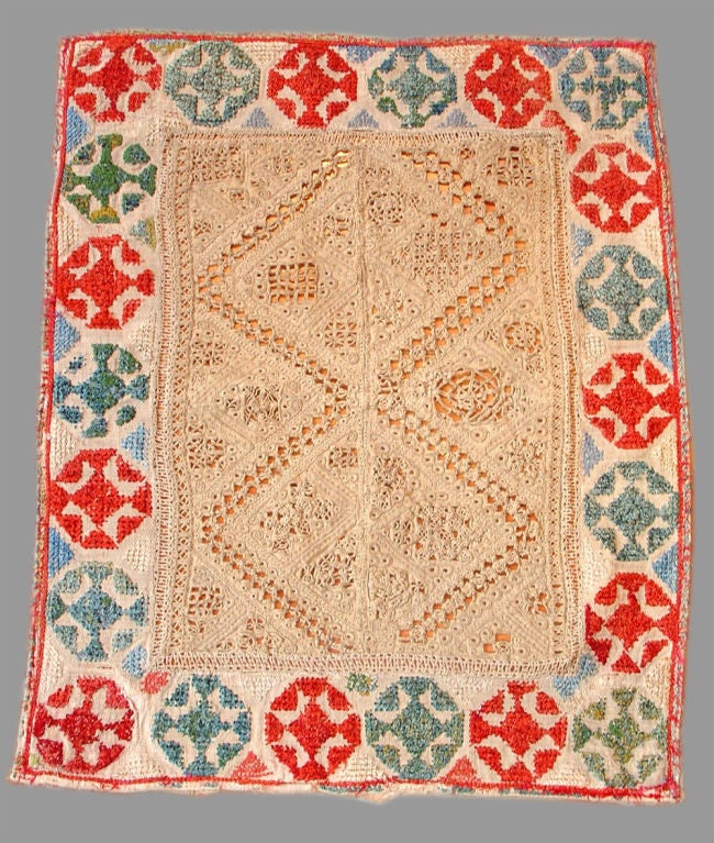 This antique Greek island embroidery uses a variety of techniques reminiscent of embroidered samplers. In terms of design, this piece reflects the Ottoman heritage of the Aegean, introduced to Greece over five-hundred years. The heavier silk floss