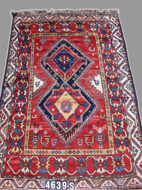 This pleasant Luri rug was handwoven using traditional techniques in southwestern Persia about one hundred years ago. It has thick lustrous pile. The colors were all derived from vegetal sources. The prominent red of both the border and the field