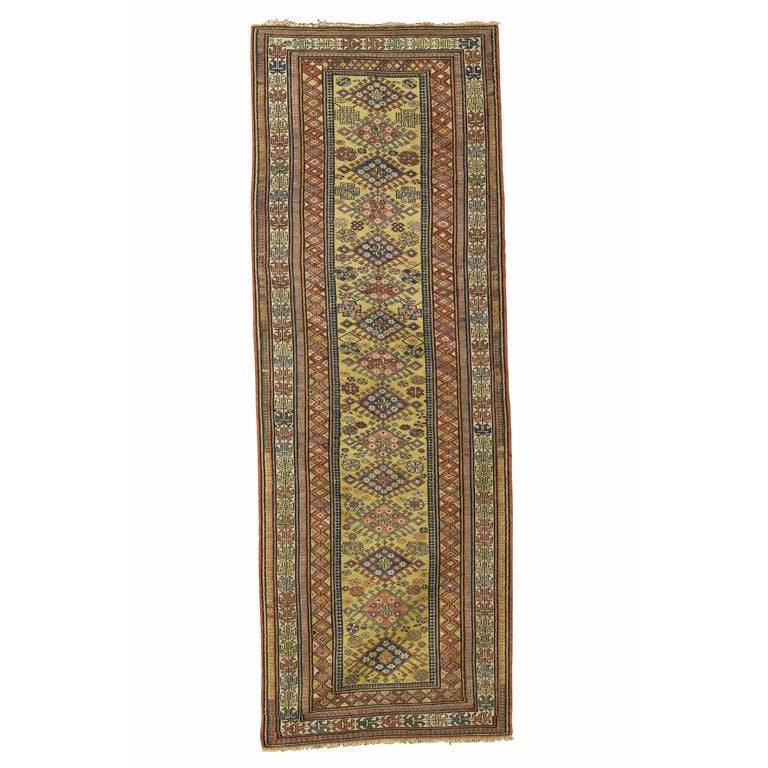 This crisp Sumak  runner was woven in the villages of the southern Caucasus about 125 years ago. A column of rams-horn traced diamond medallions is drawn on a yellow ground. While yellow ground Sumak rugs are certainly known, yellow is more rare