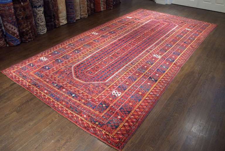 This eccentric but majestic Central Asian carpet was most probably woven by recently settled former nomads in an oasis town in the region of the middle Oxus River. The colors, especially the reds, are vibrant and all derived from natural vegetal