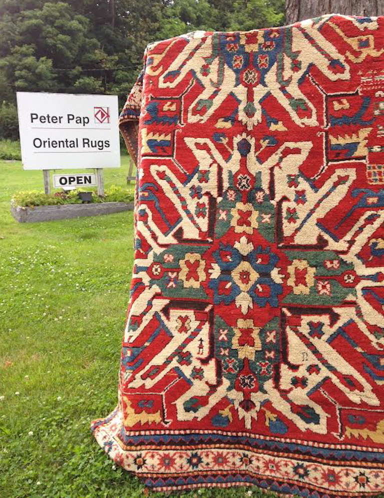 This Classic Caucasian rug was woven in the Karabagh region of the south Caucasus. Two large ‘eagle medallions,’ named for their evocation of the plumage of stretched eagle wings, are drawn in vivid color with highlights in white against a madder
