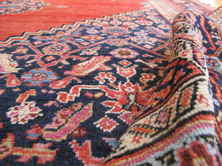 Carpets from the South Caucasian region of Karabagh often reflect a more urban aesthetic. This piece has been influenced by medallion carpet traditions from neighboring Persia. The corner-pieces are colorfully drawn with a rendition of the over-all