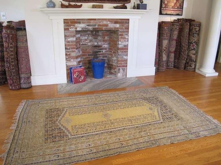 A lovely Turkish scatter rug in easy-to-live-with soft gold tones, accented by pale blue.