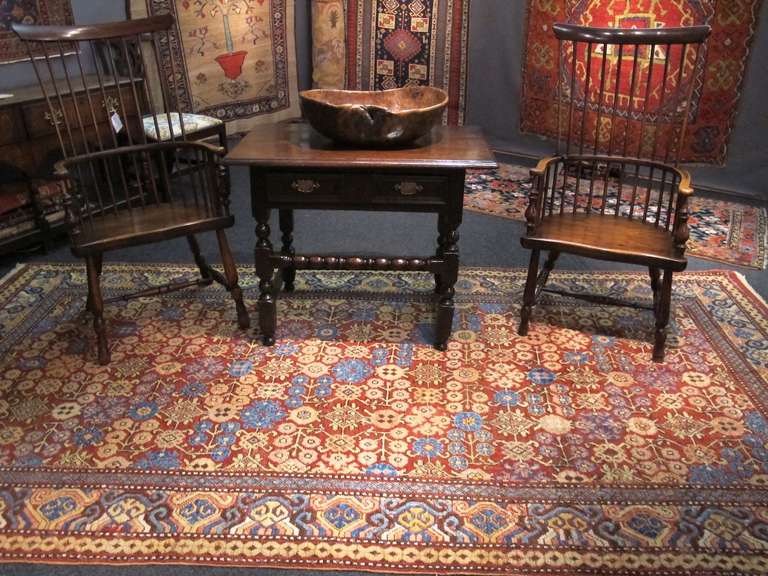 A lovely all-over design of combined pomegranate and floral blossoms on a red ground has been delicately executed in this carpet from the oasis town of Khotan in Chinese Turkestan. Depth is achieved through the subtle use of color with diagonal