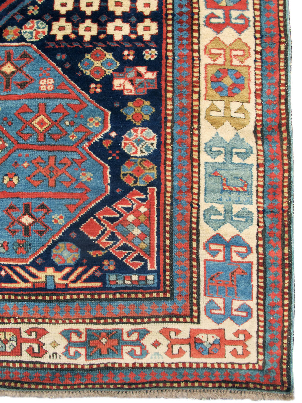 Over the years Peter Pap Oriental rugs has handled some truly exceptional Akstafa pieces from the Caucasus. We are very pleased to be offering this premiere example of the genre. Against a deep indigo ground a column of irregular medallions is drawn