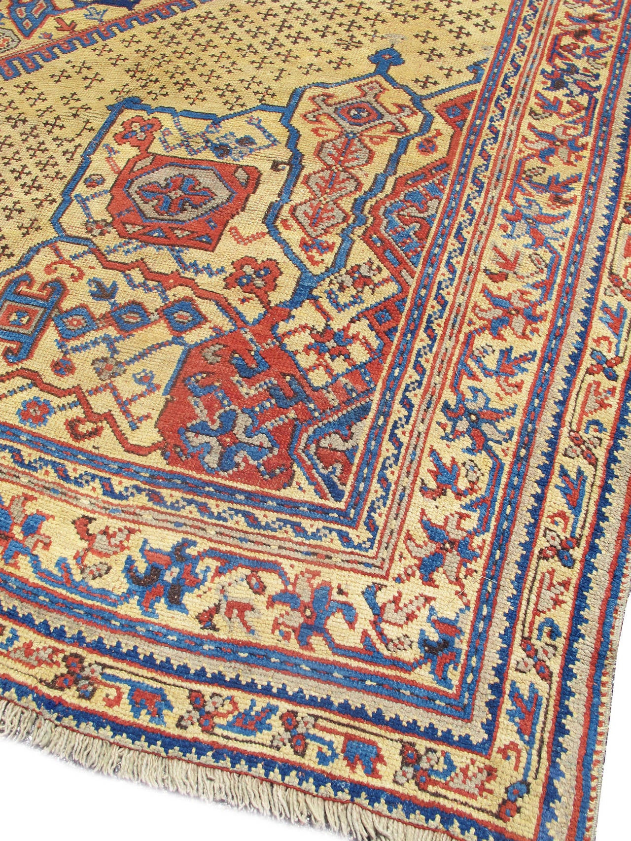 This palace-sized Oushak carpet represents the end of the Ottoman classical tradition of medallion carpets. Perhaps woven in the vicinity of Izmir or another western Anatolian weaving center more removed from Oushak itself, the lobed medallions used