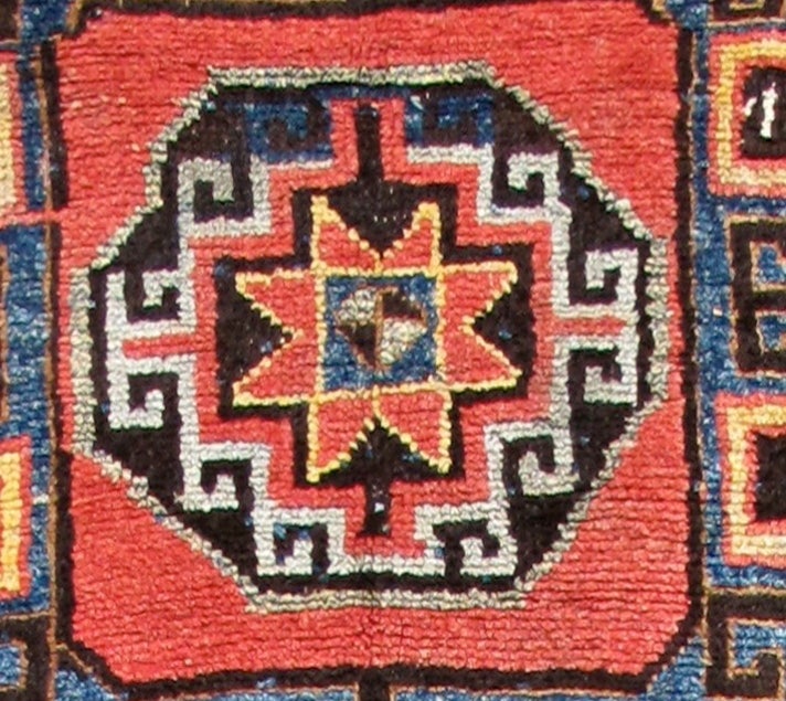 This bold village rug employs soft wool and a rustic weave. Representing design features from the related border areas of eastern Anatolia, the Caucasus and northwest Persia, this piece was most probably woven in the mountainous area of northeastern