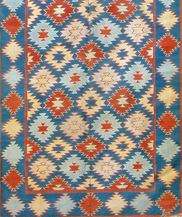 Dhurries are the quintessential Indian flat-weave. Woven with cotton, they are lightweight and were used traditionally as summer carpets. This Dhurrie uses a Classic Indian palette with lighter shades of indigo, rose, and terracotta highlighting a