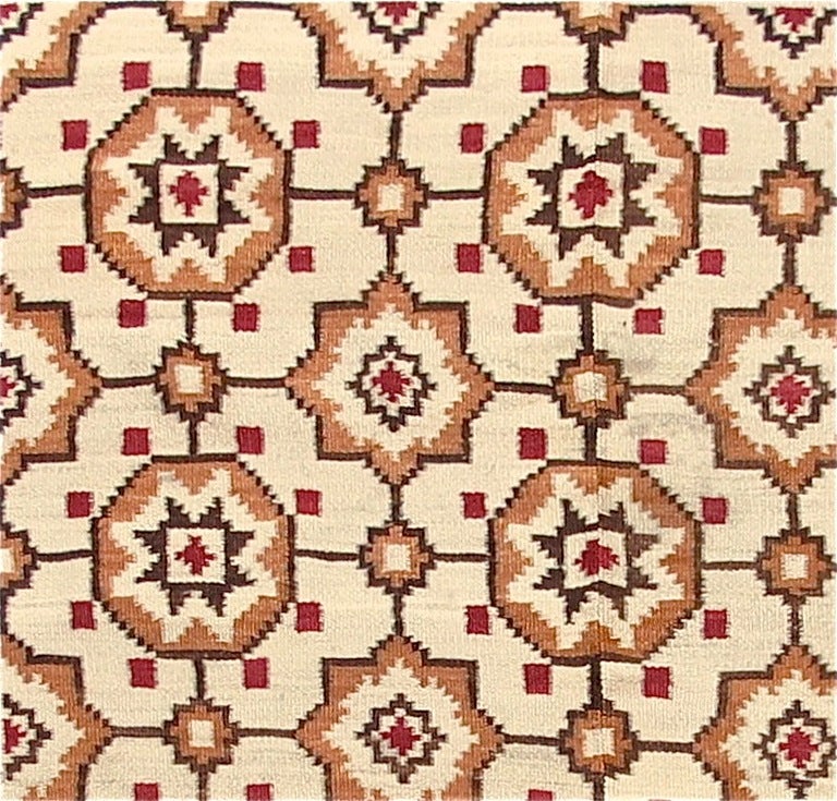 This charming flat-weave from the area of Europe bordering the Black Sea traces warm shades of chocolate brown and red on a cream background. In style and design this piece blends 19th century European with traditional ottoman models. The repeat