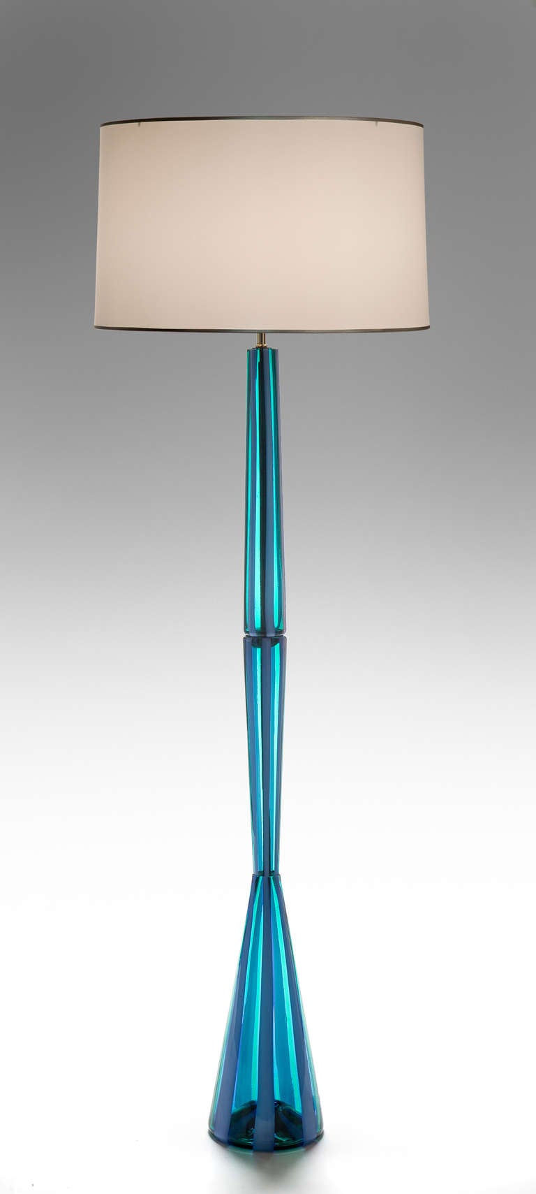 Amongst all the lamps Bianconi designed for Venini, this is arguably the best. The three-sectioned body of  emerald glass with milky blue glass stripes.

A similar lamp is illustrated by Franco Deboni, Venini Glass: Catalog 1921-2007, Turin, 2007,