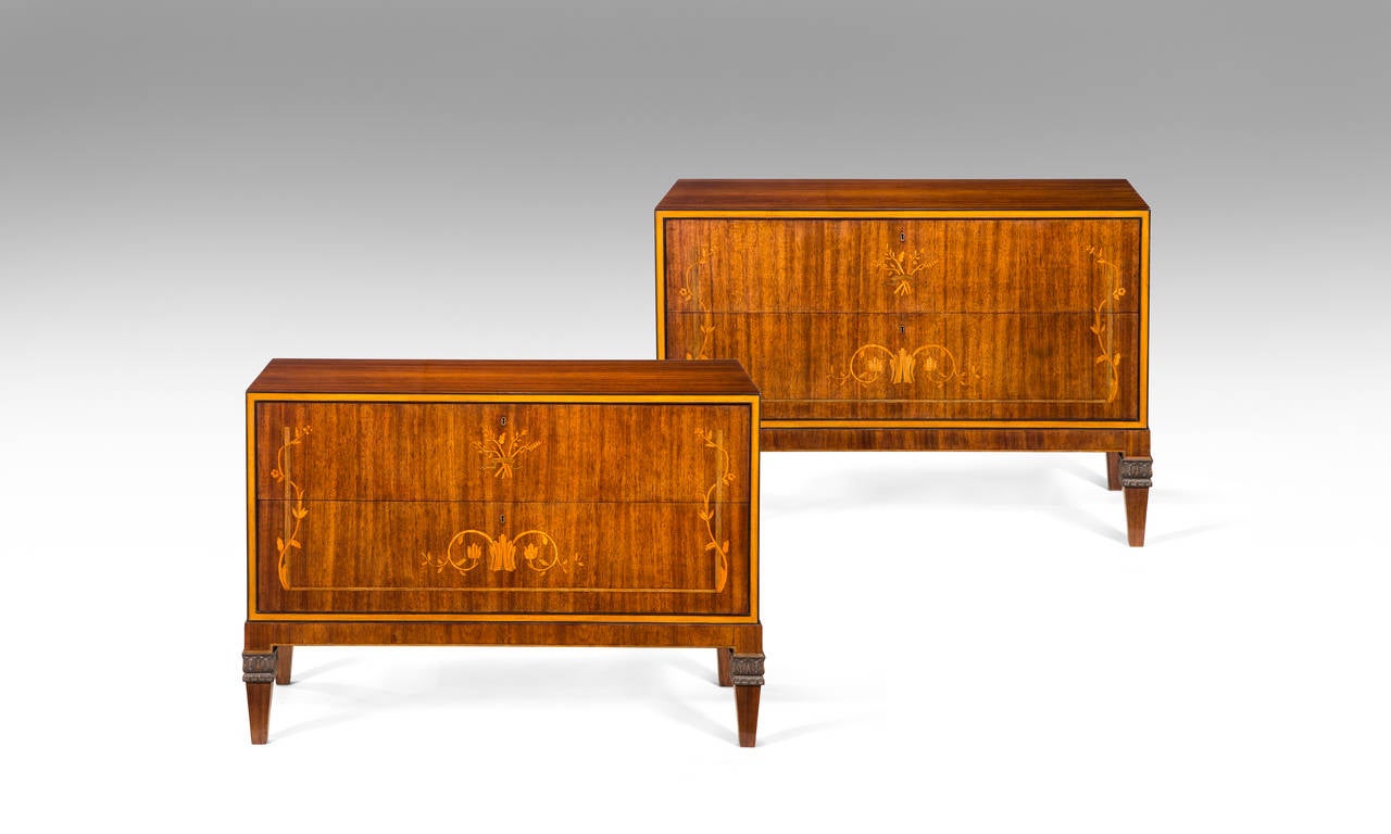 Each horizontally banded rectangular top above two drawers framed by inset light wood banding and with stylized floral inlays, raised on tapering square feet headed by foliate carving.

Labeled: A.B. HARALD WESTERBERG KUNGSGATAN 6 STOKHOLM

A