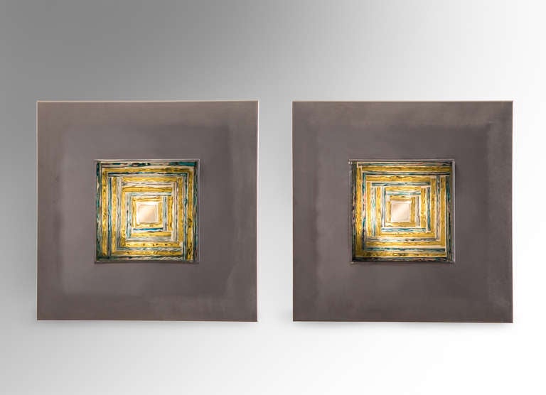 Each square composition of multicolored linear glass in a brushed and polished steel frame. 