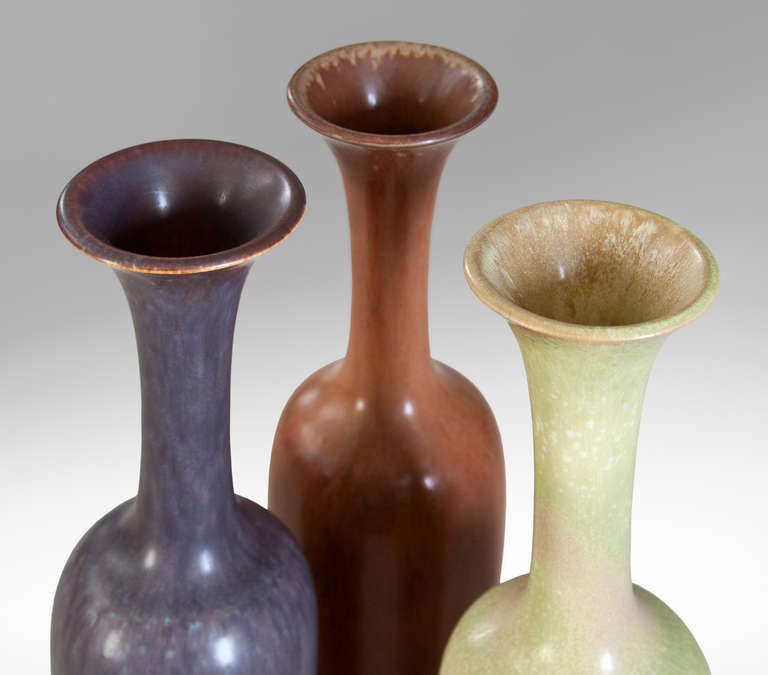 The flared mouth above an elegant, high-necked ovoid body, one each in soft green, violet, and umber glazes.

The Rorstrand ceramic works was established in 1726.  Gunnar Nylund (1904-1989) was a leading Scandinavian modernist working as a