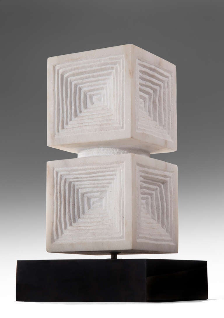 Composed of two stacked cubes incised with receding concentric squares

This piece @ H.M. Luther 
Greenwich Village
61 East 11th Street
New York, NY 10003