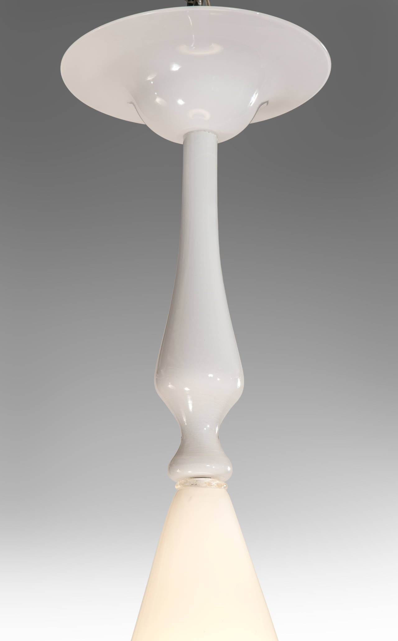 Extremely rare and elegant chandelier in the form of a lantern by Carlo Scarpa for Cappellin adorned by glass plumes and composed of beautiful milky opaque glass. The glass canopy above a shaped stem, the body composed of two opposing cones, with