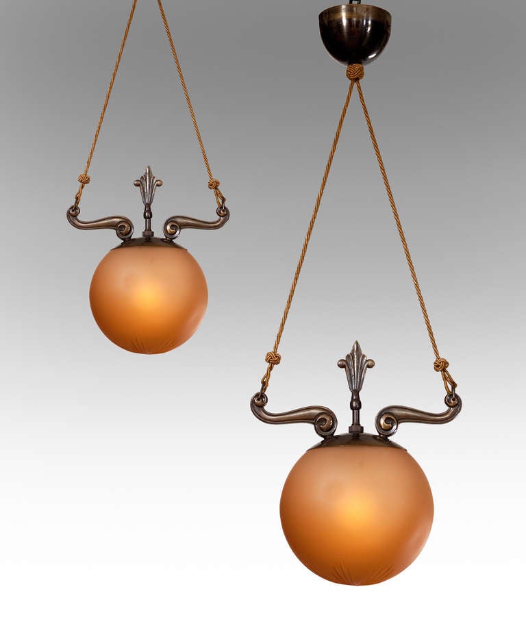 Elegant and classically inspired. The domed canopy, suspending two cords fastened to scrolled bronze arms, centering an anthemion finial, above an etched spherical glass diffuser.

Knut Hallgren (1893-1973) artist, designer and ceramist.

More