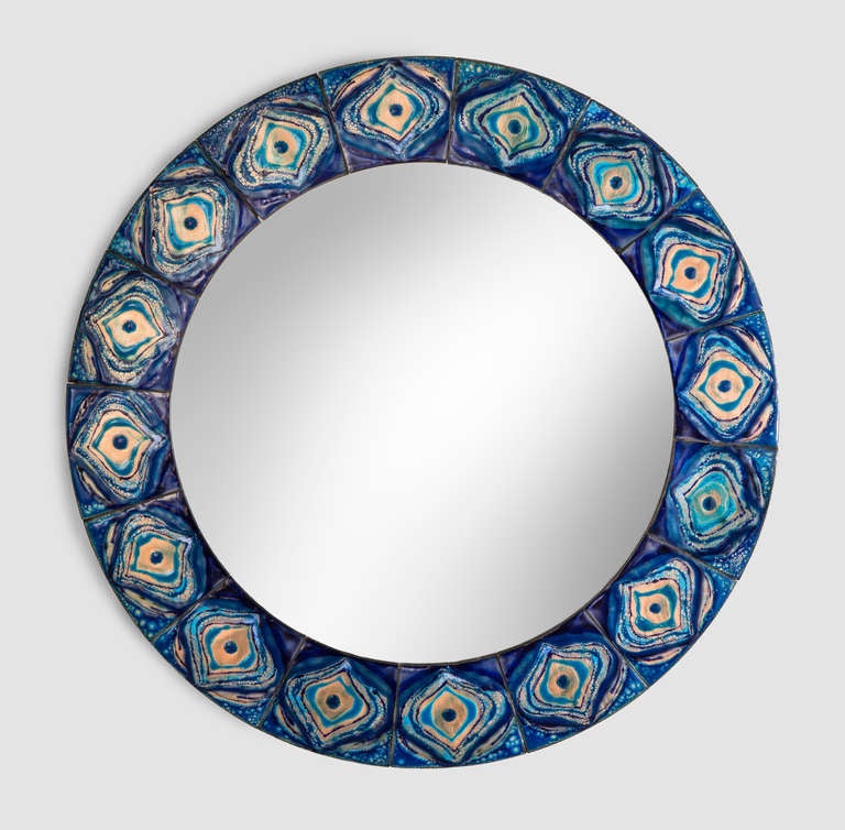 The joyful blue and white frame recalls exotic Persian ceramics. The circular mirror plate within a conforming frame composed of enameled copper panels. Labeled on the reverse: Bodil Eje 

This mirror @ H.M. Luther
Greenwich Village
61 East 11th