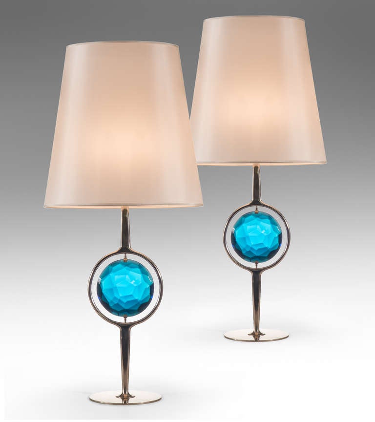 The circular floating vintage blue glass suspended within a nickel frame, raised on a round base.

These lamps @ H.M. Luther
The Carlyle
35 East 76th Street
New York, NY 10021