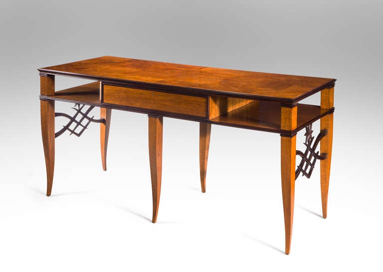 A wonderful example of Italian 1930s luxury so typified by Tomaso Buzzin and Gio Ponti.  The rectangular parquetry top with molded edges, raised on supports centering a single drawer, on six saber legs joined by finely carved wave and star