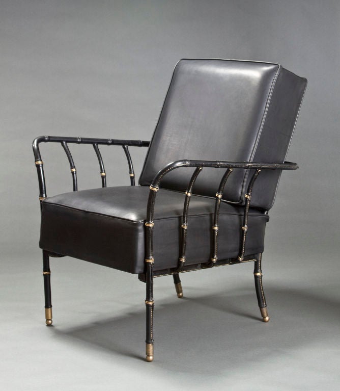 A Large Pair of Brass Mounted Leather Armchairs by Jacques Adnet 1