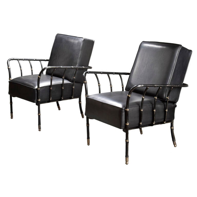 A Large Pair of Brass Mounted Leather Armchairs by Jacques Adnet