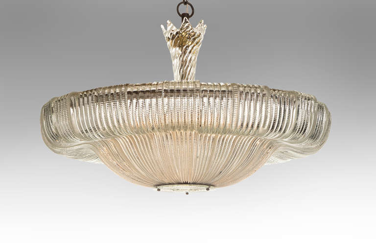 Like a sheer cloth caught in a gentle descent, the billowing curves of this early design are as avant-garde as they are beautiful.  The unfurling glass canopy above a floating facetted glass body, centering a studded glass medallion.  The height can