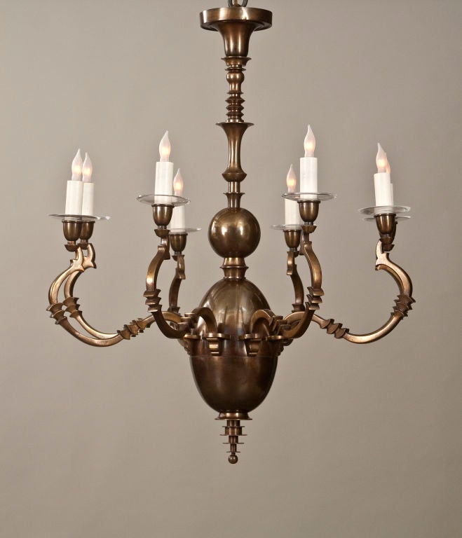 The conical corona, above a turned standard, surmounting an ovid body issuing eight curved arms, each with a bobeche and light holder, terminating in a graduated finial. <br />
<br />
This piece @ H.M. Luther Antiques<br />
Greenwich Village<br