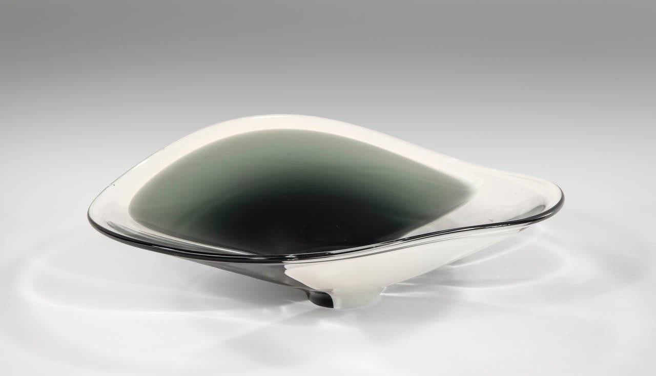 The floating round composition of encased white and deep-green glass on a circular base. Model 1304.

Provenance: A Danish Private Collection

A rendering of this bowl is illustrated in Per Lütken - glas et liv, Copenhagen, 1986, unpaginated.