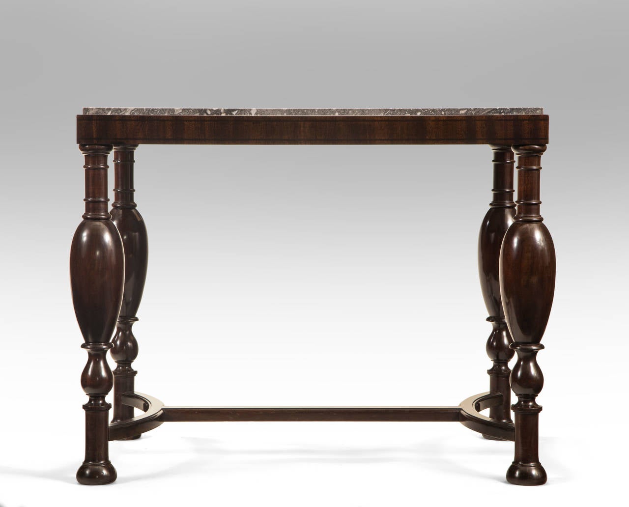 A sophisticated and elegant design. The rectangular marble top within a wooden frame, above stylized baluster legs joined by stretchers, early 20th century, circa 1925.