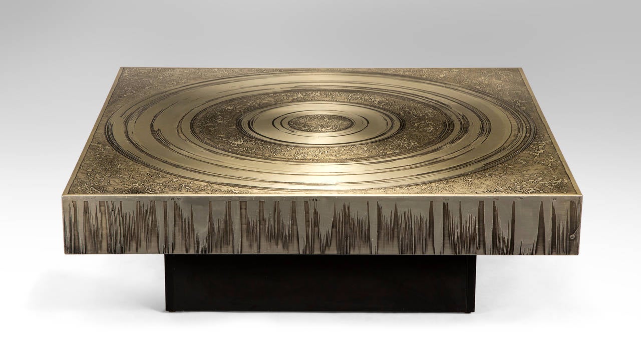 The square top displaying sculpted concentric circles over a drip-pattern background, the conforming apron above a recessed ebonized base. Signed: Marc D'Haenens