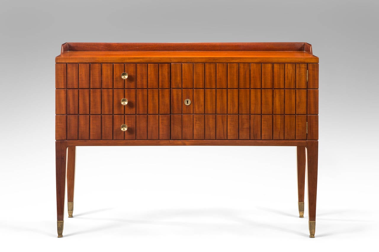 Well crafted in beautifully figured, radiant mahogany. Each rectangular top, above three stacked drawers, one cabinet with an open shelf, the other with a cabinet door, raised on tapering square legs, terminating in brass sabot.