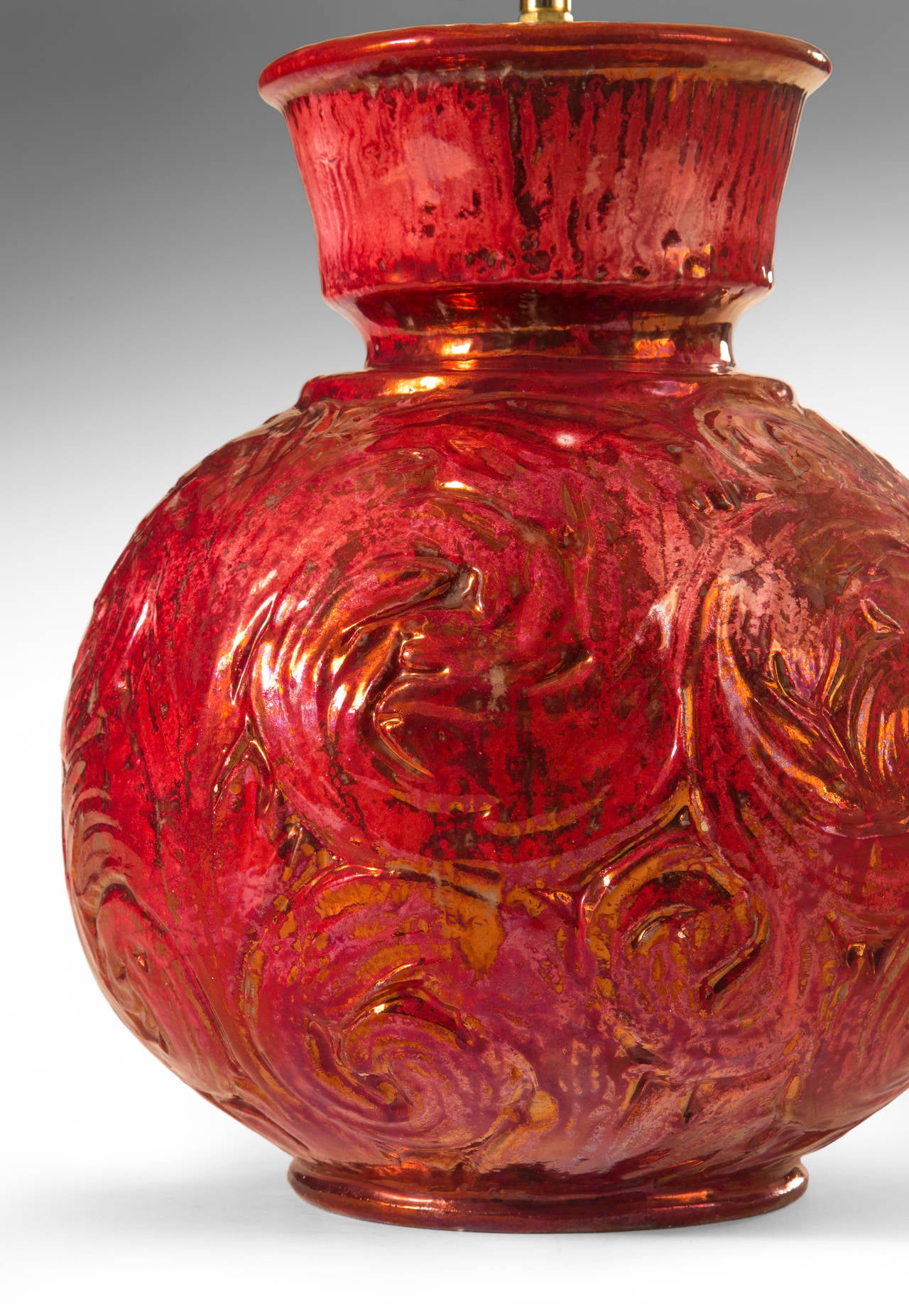 A highly unusual and beautifully executed glaze for Hammershøi. The tapering and fluted neck, recessed above a spherical body adorned with overlapping spirals. The whole in deep iridescent red glaze. Signed: HAK Danmark

Museum wired.