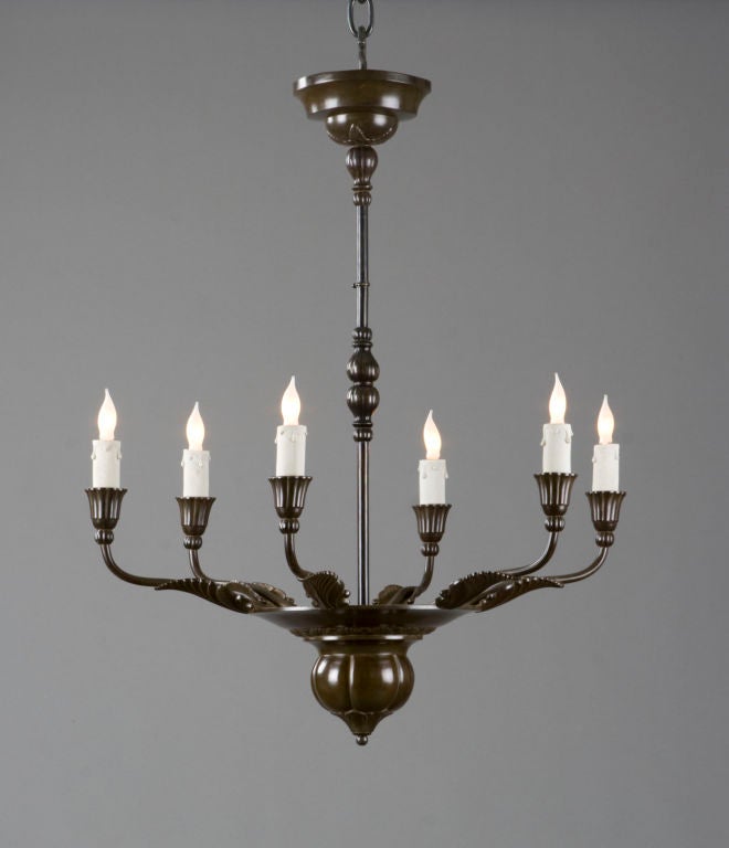 The molded canopy joined to the slender standard, the circular dish with a foliate frieze above a large lobed sphere, issuing six acanthus leaf mounted candlearms ending with fluted trumpet-form candleholders. <br />
<br />
This piece @ H.M.