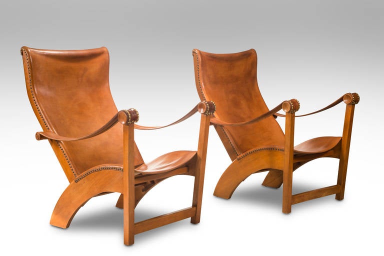 A rarely available identical pair in beautifully patinated old leather. Mogens Voltelen's groundbreaking Copenhagen chair represents the first of the iconic, sculptural designs by Finn Juhl, Hans Wegner, and Arne Jacobsen, amongst others, that