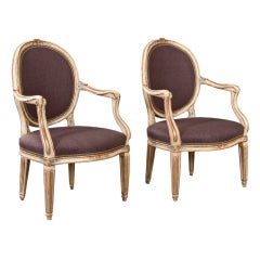 A Pair of Neoclassical Painted and Parcel Gilt Arm Chairs