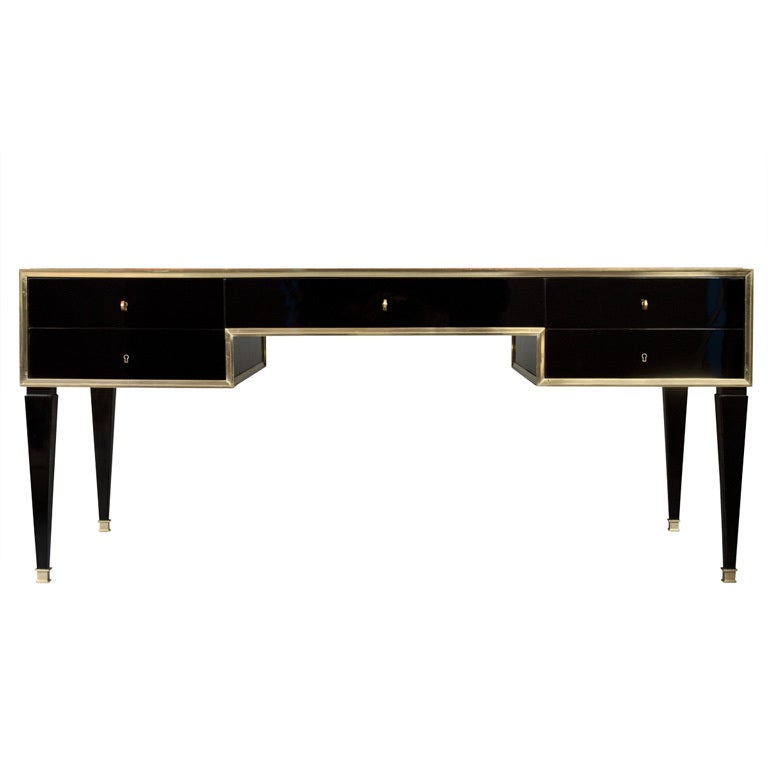 A Brass, Patinated Leather and Ebonized Desk by Marc du Plantier