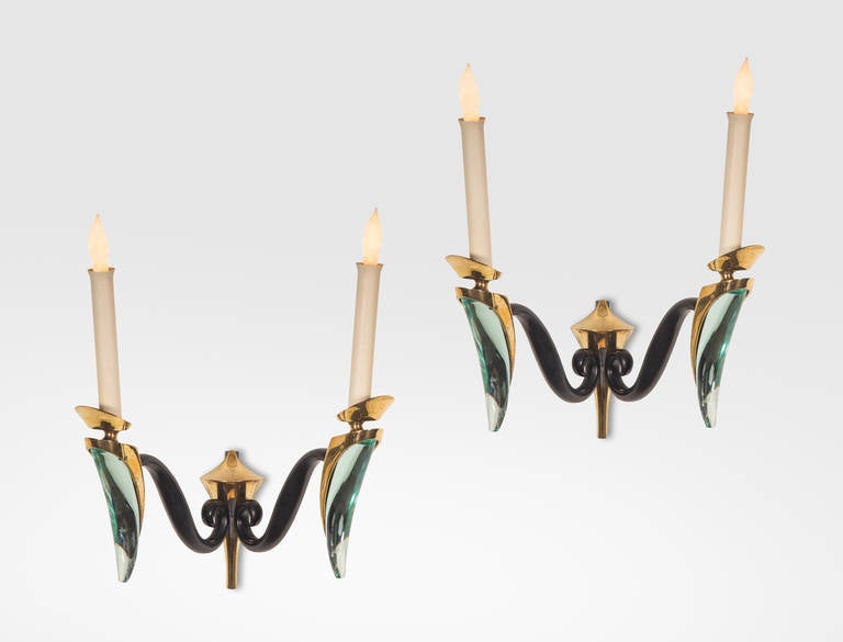 From the same collection of designs selected by Max Ingrand for his home in Neuilly-sur-Seine. Each backplate issuing two S-scrolled arms, each arm supporting a single light holder above a brass and beautifully hand-sculpted glass stem.