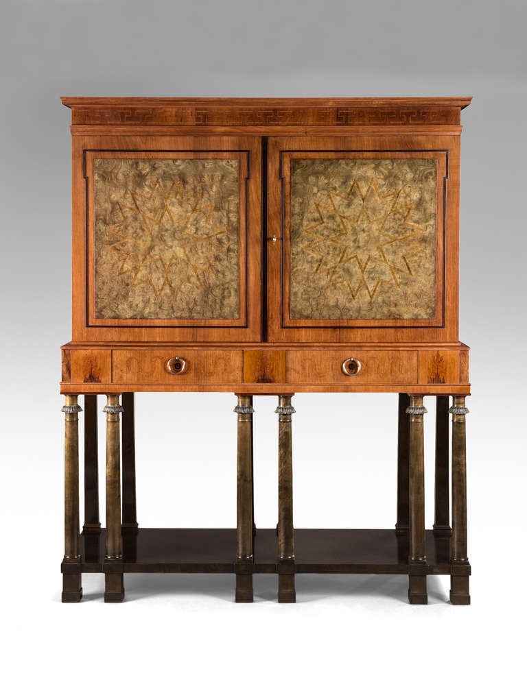 This remarkable cabinet exemplifies the Swedish Grace movement's synthesis of modernity and the Classical idiom. Executed to the highest levels of craftsmanship and undoubtedly a unique commission. The rectangular molded crown above an inlaid Greek