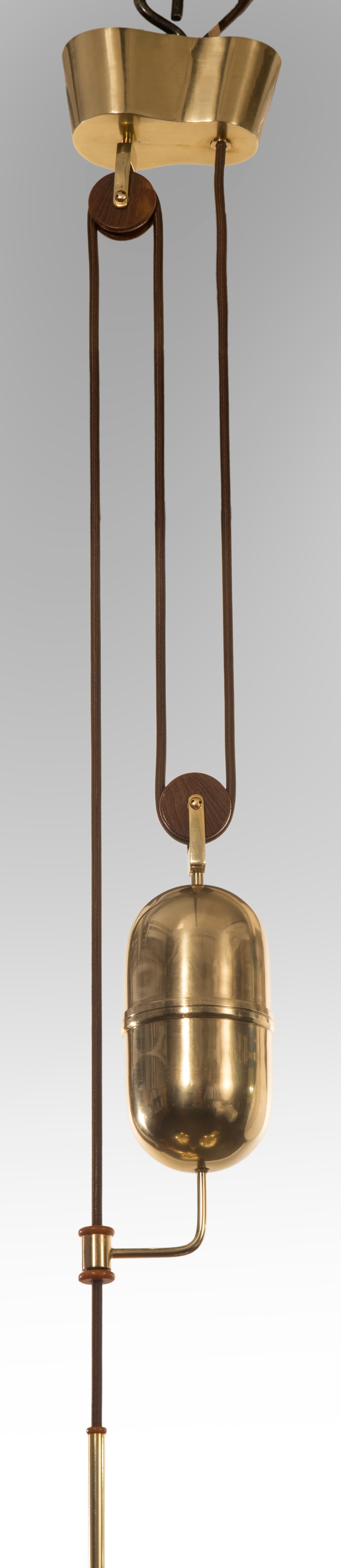 Bertil Brisborg for Bohlmarks: An Adjustable Brass, Bakelite and Wood Chandelier In Excellent Condition In New York, NY