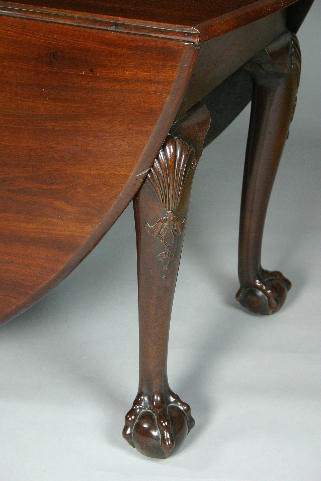 Fine George II mahogany oval drop leaf table on cabriole legs, carved at the knees with shells and bellflowers and ending in ball and claw feet. English, Circa 1750. 
Height 29 ins / 74 cms, Width 75 ins / 191 cms, Length 67 ins / 170 cms