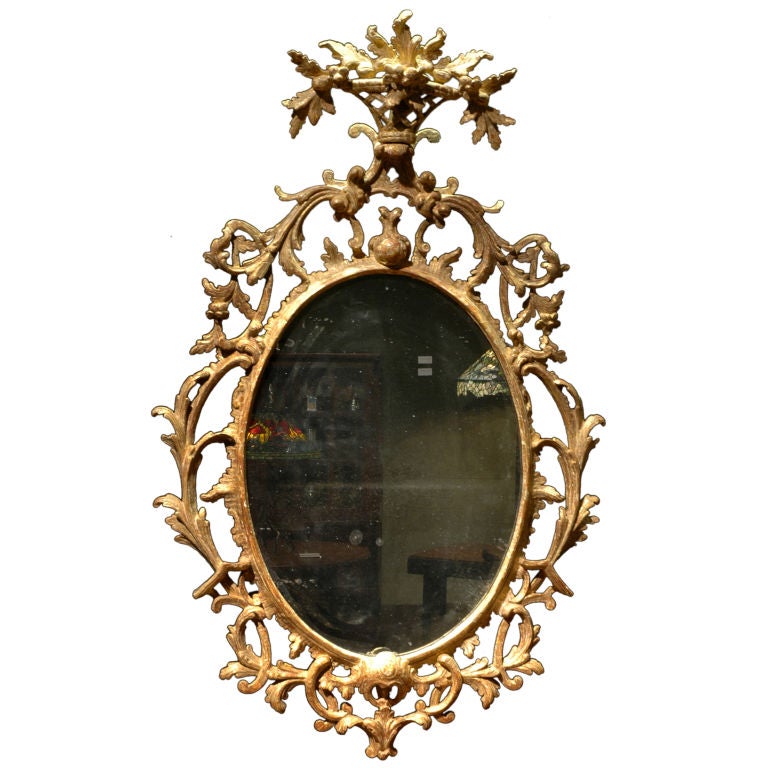 Oval Rococo Mirror, Crested with a Carved Floral Basket For Sale