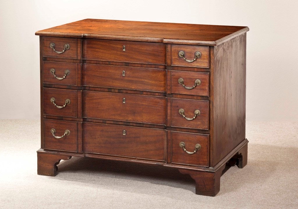 A mahogany block front chest with a writing slide, central drawer to the top drawer and two hidden drawers in lining over three drawers.